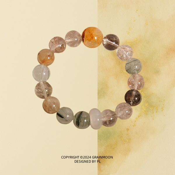 Bracelet: rutilated quartz beads with golden, red, green and black needle-like inclusions