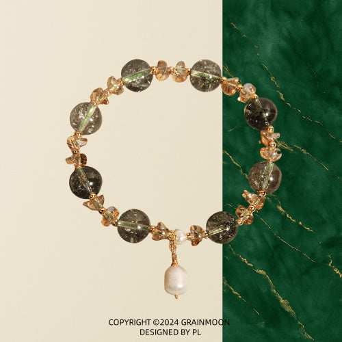 Bracelet: dark green phantom quartz beads with small crystal chips and a white baroque pearl drop