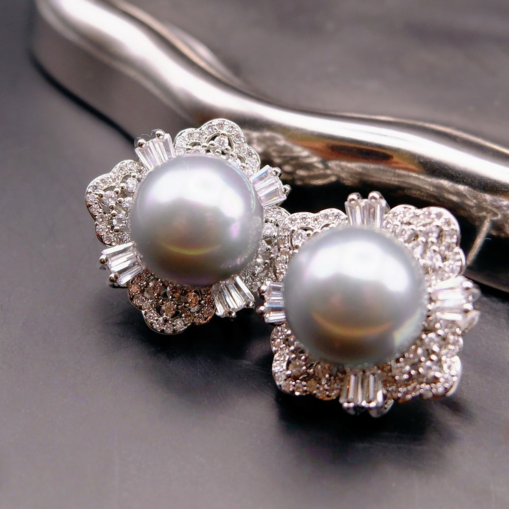 Earrings: two grey cultured Tahitian pearls in flower-shaped halos, second view