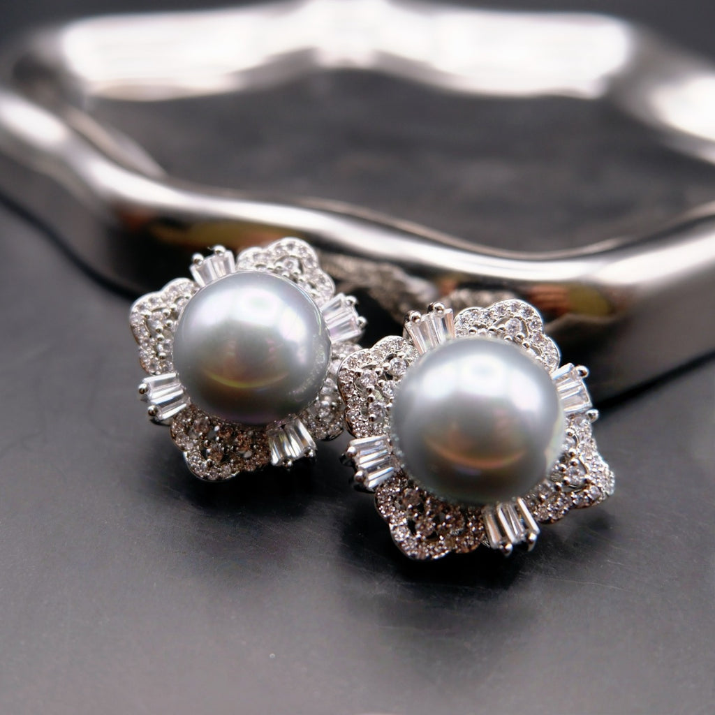 Earrings: two grey cultured Tahitian pearls in flower-shaped halos, third view