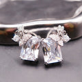 Earrings: clear emerald-cut stones topped with butterfly and flower motifs, 925 sterling silver setting