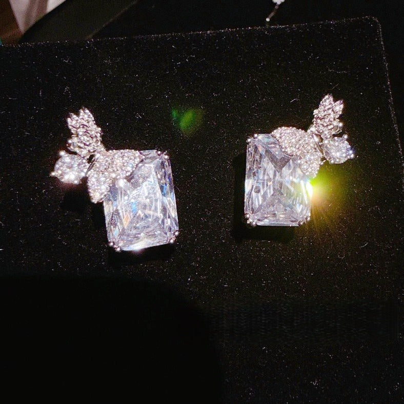 Earrings: clear emerald-cut cubic zirconia with butterfly and flower motifs, second view