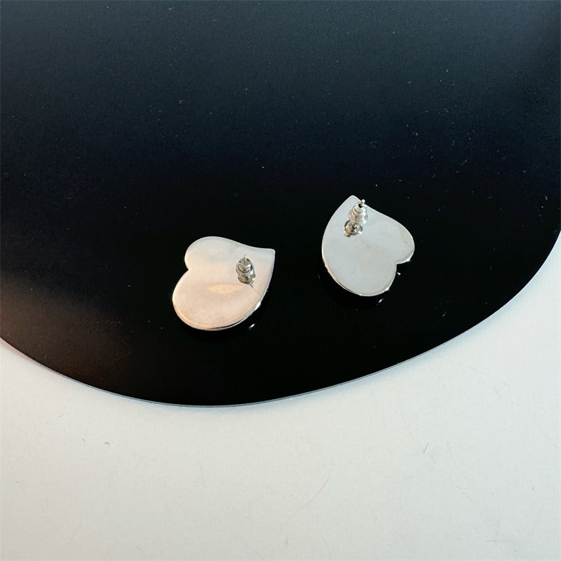 Earrings: iridescent black mother-of-pearl teardrops in a heart shape, third view