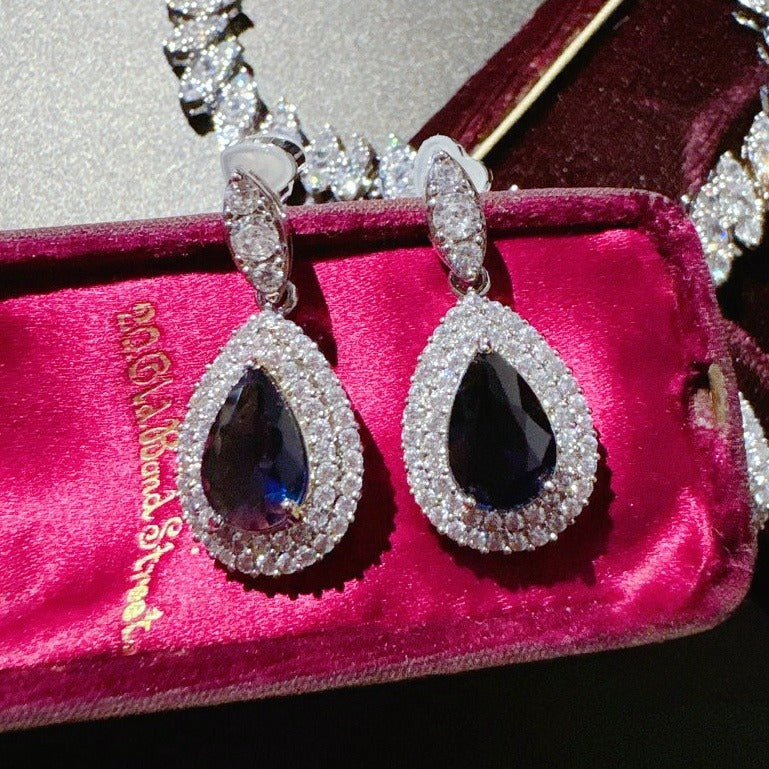 Earrings: royal blue pear-cut stones in halos of lab-created cubic zirconia, second view
