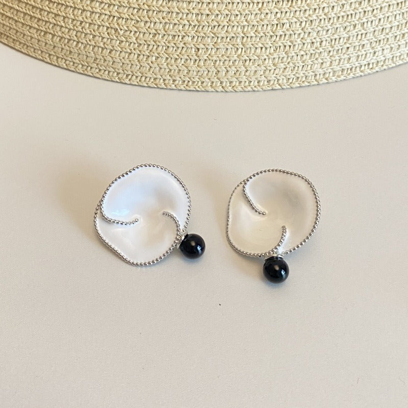 Earrings: white enamel crown of thorns flowers, two rounded lobes with a silver-coloured beaded edge, and a black bead drop