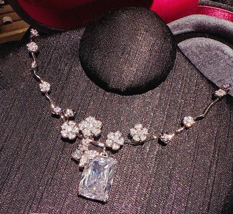 Necklace: clear emerald-cut cubic zirconia below a butterfly on a vine chain, second view