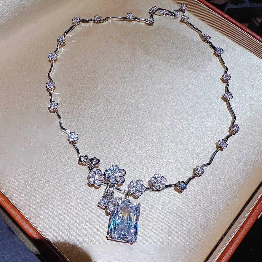 Necklace: clear emerald-cut cubic zirconia below a butterfly on a vine chain, fourth view