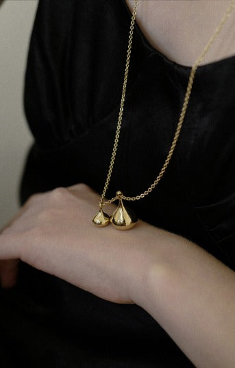 Necklace: long chain with two rounded sculptural drop pendants, second view