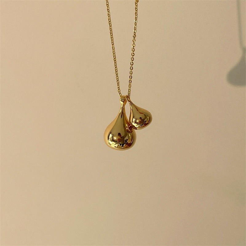 Necklace: long chain with two rounded sculptural drop pendants, fifth view