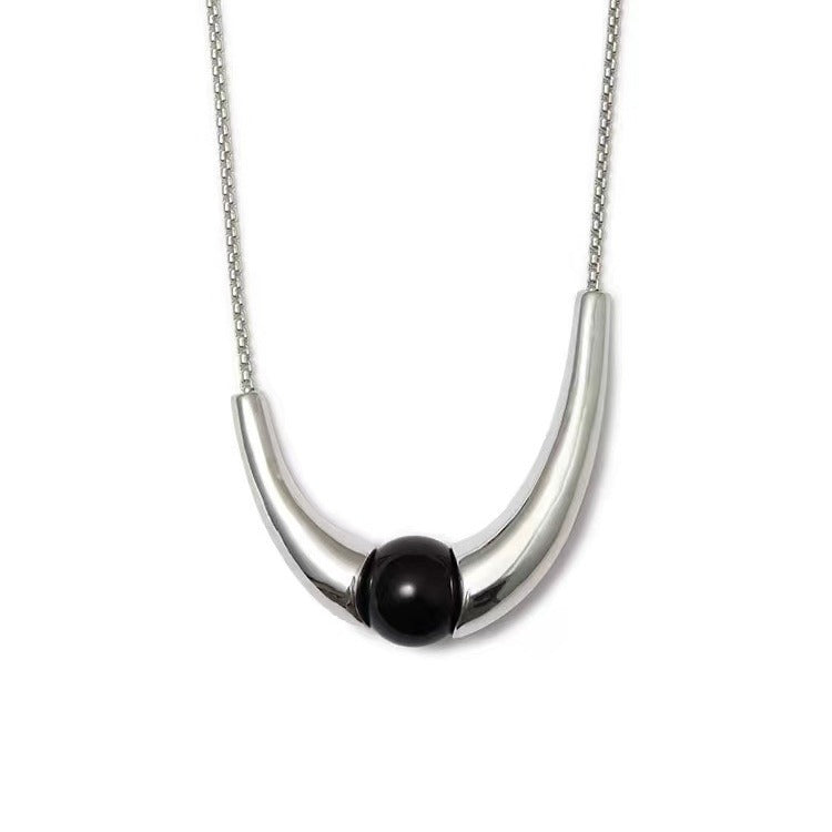 Necklace: round black agate bead held in a polished curved 925 sterling silver arc on a chain
