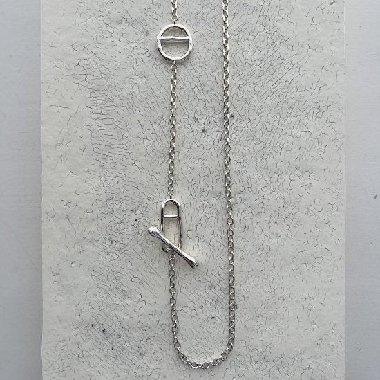 Necklace: long polished chain with two oval links and a T-bar toggle, third view