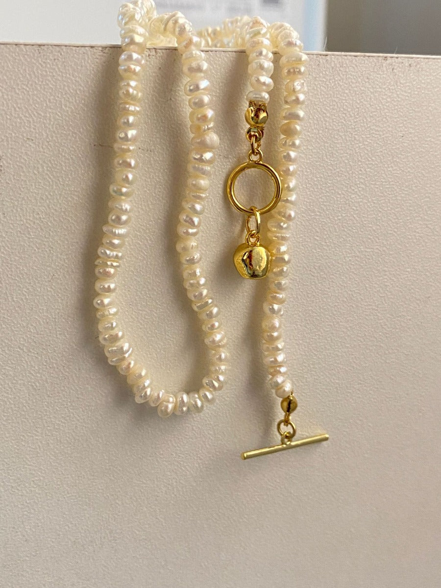 Necklace: strand of small ivory freshwater rice pearls, 3-4mm, fifth view