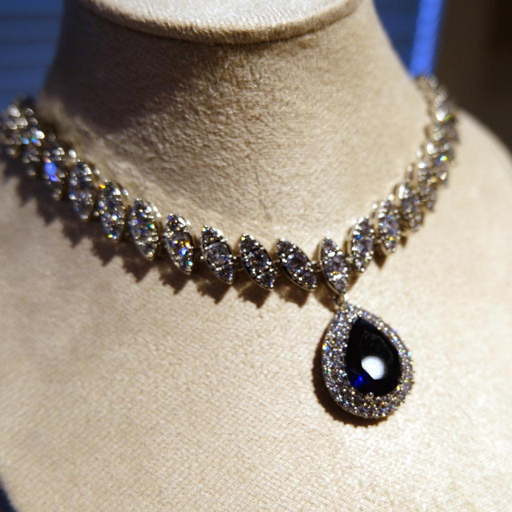 Necklace: royal blue pear-cut stone in a halo pendant on a marquise-stone chain, third view