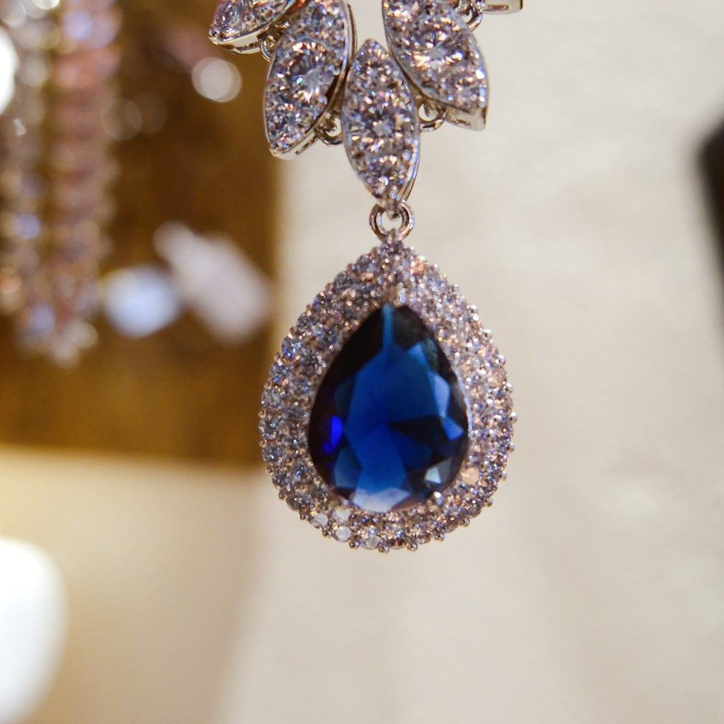 Necklace: royal blue pear-cut stone in a halo pendant on a marquise-stone chain, fifth view
