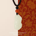 Pendant: pale green-white Hetian jade carved as a Pixiu, with black and red beads on a black cord