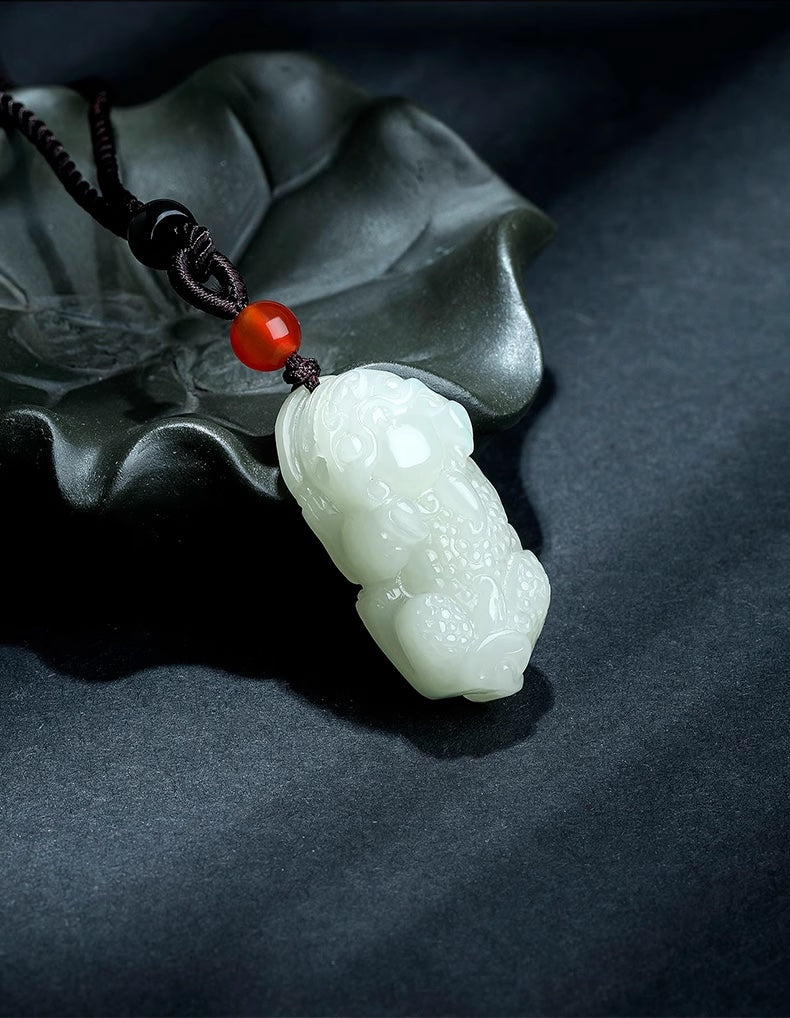 Pendant: pale green-white Hetian jade carved as a Pixiu on a black cord, second view
