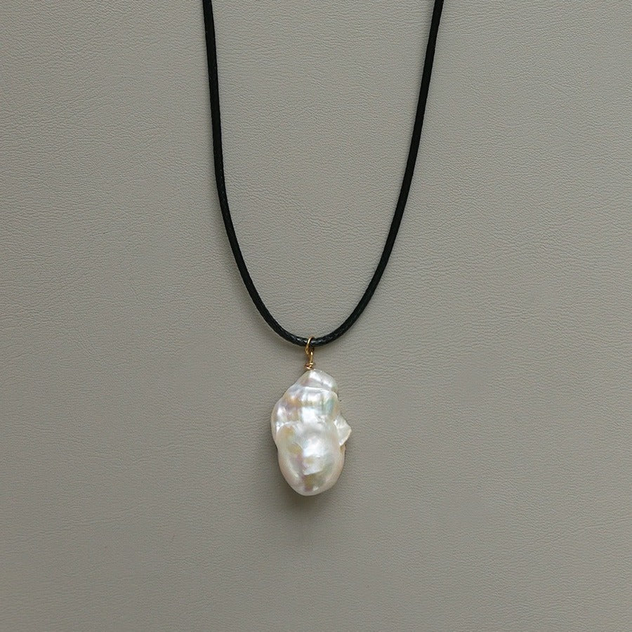 Pendant necklace: white baroque freshwater pearl on a black cord