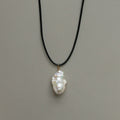Pendant necklace: white baroque freshwater pearl on a black cord