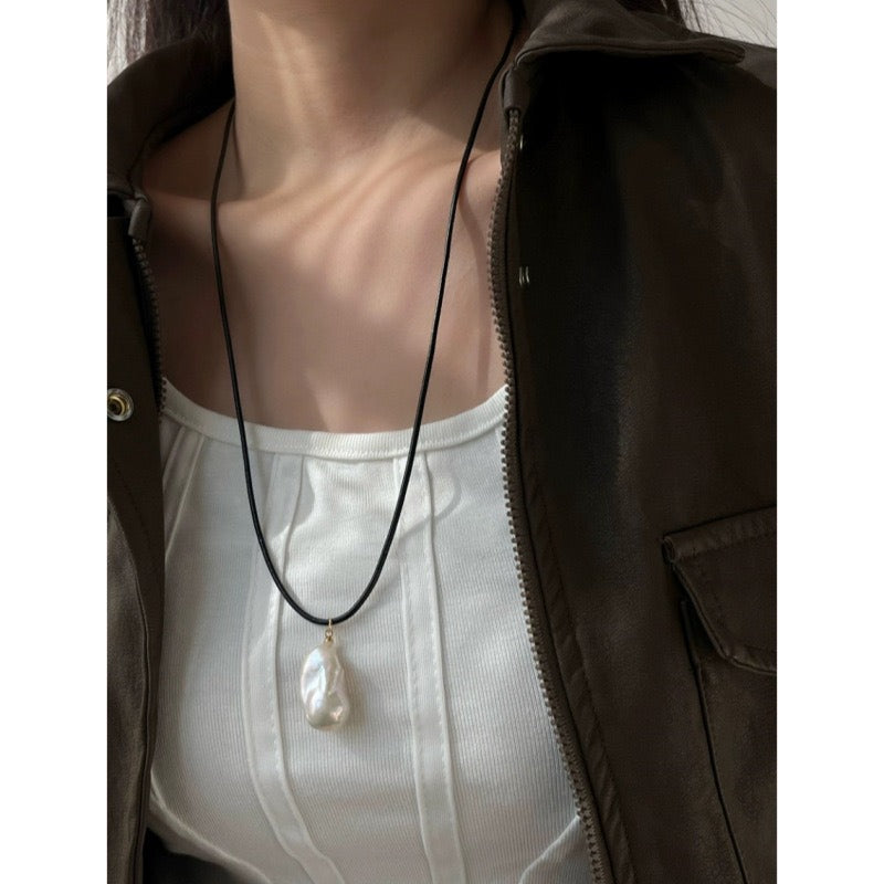 Pendant necklace: white baroque freshwater pearl on a black cord, third view