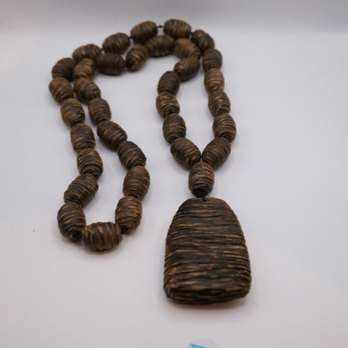 Pendant necklace: dark brown striped Vietnamese agarwood pendant on carved beads, third view