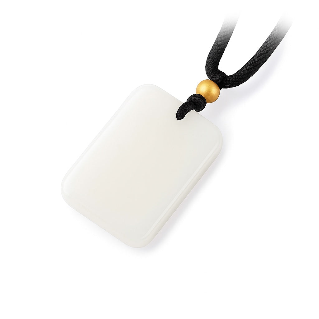 Pendant: white rectangular Hetian jade plaque with a gold bead on a black cord, second view